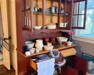 Farmhouse buffet with hutch houses a large collection of Longaberger pottery and Armetale pewter.