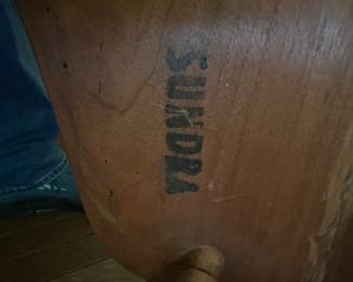 Stamp under Nakashima dining chairs