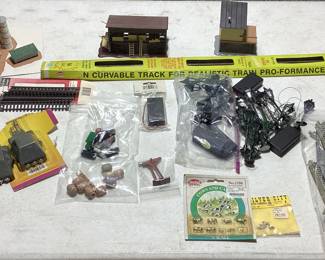 HO TRAIN TRACKS AND ACCESSORIES LOT LOT INCLUDES TRACKS, STRUCTURES POWER SWITCHING DEVICES, MINIATURE PEOPLE AND LIVESTOCK