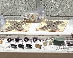  LARGE LIONEL O & O27 GAUGE TRAIN COLLECTION THIS LOT FEATURES THE LIONEL 6-11906 COMPLETE SET WITH ENGINE AND FUNCTIONAL. ALSO INCLUDES SANTE FE ENGINE(NEEDS SERVICE AND OILING) EXTRA CARS, DEPOT STATIONS, GATEMAN, ATLAS CONNECTORS, SWITCH TRACKS, MINIATURE PEOPLE AND LIVE STOCK, APPROX. 75 FEET OF TRACKS, EXTRA TRANSFORMER, STREET LIGHT AND LIGHTING CONTROLLER, ADDITIONAL STRUCTURES AND MORE