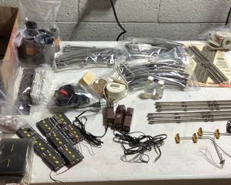  LARGE LIONEL O & O27 GAUGE TRAIN COLLECTION THIS LOT FEATURES THE LIONEL 6-11906 COMPLETE SET WITH ENGINE AND FUNCTIONAL. ALSO INCLUDES SANTE FE ENGINE(NEEDS SERVICE AND OILING) EXTRA CARS, DEPOT STATIONS, GATEMAN, ATLAS CONNECTORS, SWITCH TRACKS, MINIATURE PEOPLE AND LIVE STOCK, APPROX. 75 FEET OF TRACKS, EXTRA TRANSFORMER, STREET LIGHT AND LIGHTING CONTROLLER, ADDITIONAL STRUCTURES AND MORE