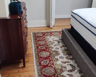 rugs and dressers and TV and lamps