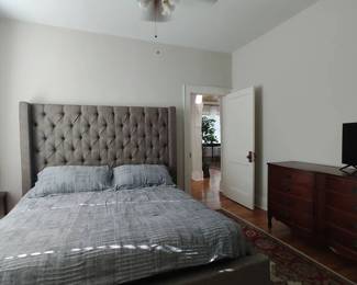 King size bed with grey tufted headboard, frame and mattress