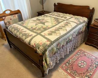 Full-size bed with mattress and box spring.
