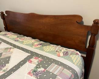 Closer view of the headboard on the full-size bed with mattress and box spring.