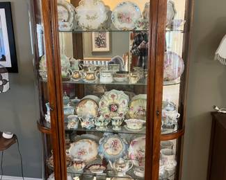 One of two matching china cabinets showcasing an exceptional collection of antique porcelain and china.
