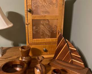 Small farmhouse-style cabinet and other carved wood items.