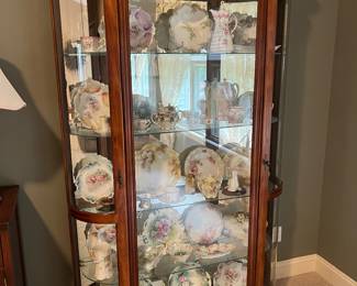 One of two matching china cabinets showcasing an exceptional collection of antique porcelain and china.