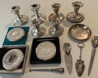 Nice selection of sterling silver items, including multiple matching candlesticks, three Towle compact mirrors, and a Gorham owl letter opener and bookmark.