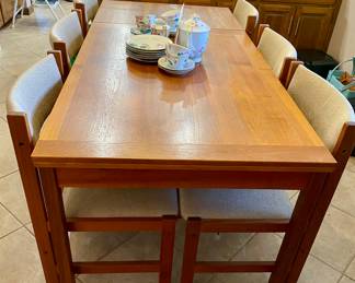gorgeous teak with fold out ends and 7 chairs