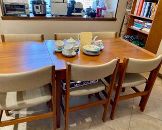 gorgeous teak with fold out ends and 7 chairs