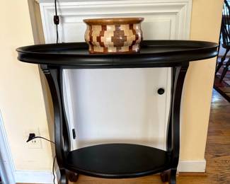 An unusual wood oval console table.
