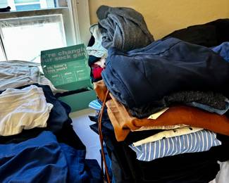 Three tables full of clean folded clothes! Jeans, sweats, teeshirts,& casual ware.