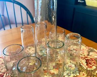 Unique pebbled glass carafe and glass set.