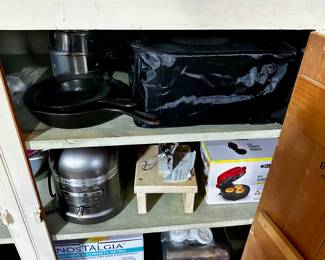 Cast iron fry pans and crockpot hook up in storage bag.