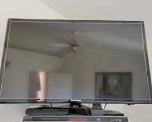 Samsung Flat Screen TV with Panasonic DVD Player and Multiple Remote Controls