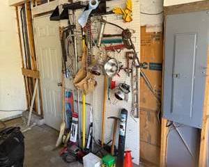 Vintage Hand Tools, Work Gloves, Heavy Duty Chains, and Task Lighting on Pegboard
