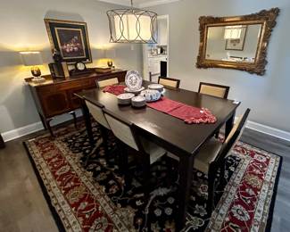 Lovely dining room table & chairs, area rug, gold guilted mirror and antique buffet