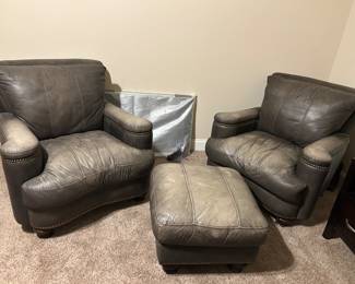 Pair of leather club chairs and ottoman