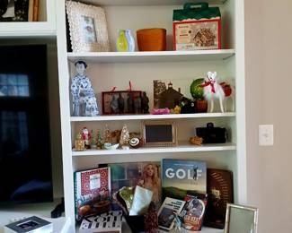 shelves in living room with decor, books, etc