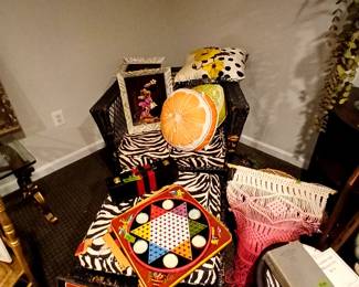 chinese checkers, variety of decorative pillows, macrame wall hangings, woven foot stool, painting on velvet of desert