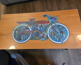 Puzzle Art Design on Coffee Table Top, can be removed from under the glass. Marks in photo are a reflection of the lights overhead.  There is no damage to the top.  Great Condition.