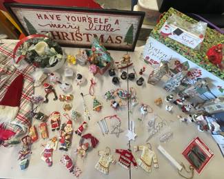 "A set of Christmas Carolers,  (1) light up Kirkland's floral decor Christmas collection, (2) Cardinals (4) ceramic buildings -school,church, shop,antiques,  (1) Christmas sign that says ""Have yourself a Merry  little Christmas"", assortment of ornaments,  (1) tree skirt, (2) gift box. "