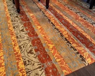 2 large area rugs in bright oranges and golds