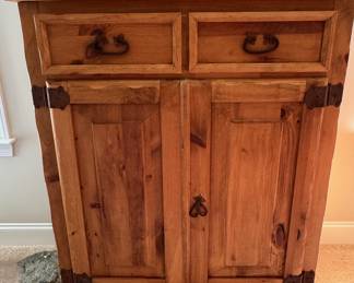 Chest has two drawers and doors open to two shelves.