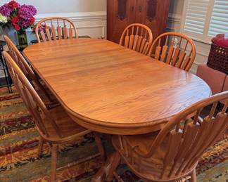 Oak dining table with 6 chairs (two are arm chairs). One water mark, excellent condition.