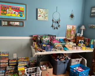 Kids room is full of toys, dolls, clothes and videos