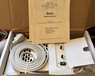 Living Air Bora electronic air purification system. Device in box with manual and power cord