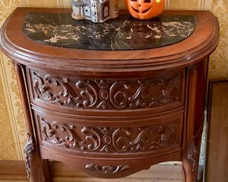 Carved table with drawers and carved legs