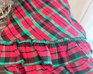 this beautiful plaid from the 80s is made of rayon. It's still silky. It goes on a round table and it is floor length it goes to the floor.