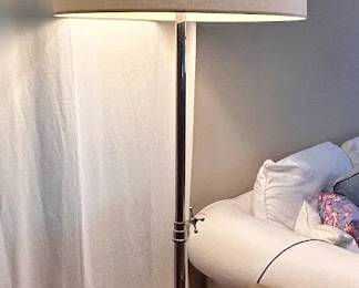 Chrome tripod floor lamp with a drum-style linen shade