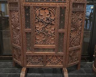 Carved wood fireplace screen