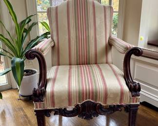 Striped accent chair with carved wood trim
