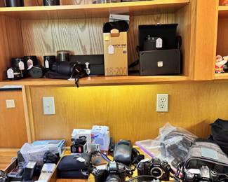 Cameras, lenses, camera equipment galore. Also many binoculars.