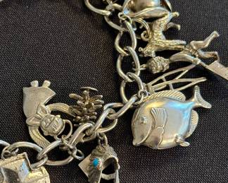 Vintage sterling silver charm bracelet with 18 sterling charms