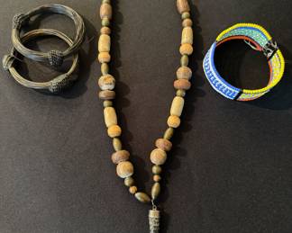Vintage African pieces, including a wood & clay beaded necklace with a Dik Dik horn pendant