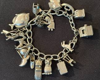 Vintage sterling silver charm bracelet with 18 sterling charms