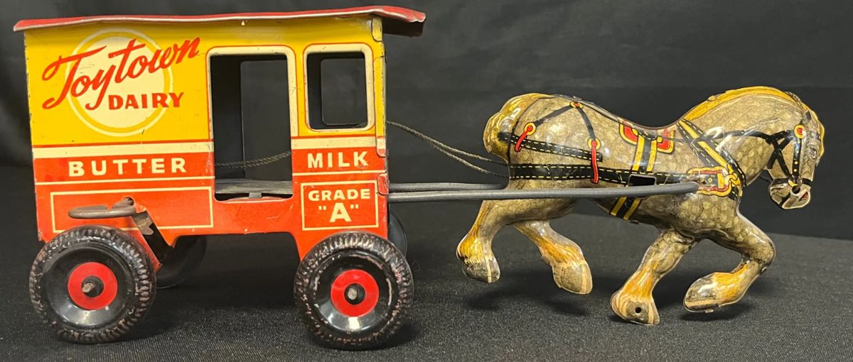 Vintage 1930s Marx “Toytown Dairy” Wind-Up Tin Litho Horse & Wagon Toy
Classic pre-WWII Marx Toytown Dairy wagon, complete with lithographed horse & wagon marked “Milk • Butter • Cheese • Grade A.”
• Made by Louis Marx & Co., New York, c. 1930s
• Tin lithograph construction with rope reins & metal axles
• Bright red, yellow, & cream graphics still visible with expected surface wear
• Approx. 9″ long (see ruler in photos for scale)
• Some light oxidation & paint loss from age