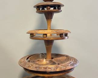 Vintage Hand-Carved Monkey Pod 3-Tier Lazy Susan with Removable Bowls
Striking vintage 3-tier lazy Susan made of richly grained monkey pod wood with detailed hand carvings of tropical scenes & animals. Perfect for mid-century entertaining or display!

• Stands approx. 33” tall
• Largest tray: 18” diameter
• Middle tray: 14” diameter
• Top tray: shown in photos for scale
• Includes (8) removable serving pods (two size variations)
• Two stand spacers need reglued; top piece slightly wobbly
• Beautiful carved detail throughout with a warm patina
