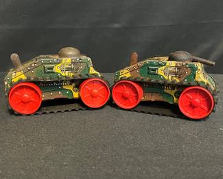 (2) Vintage 1950s Louis Marx “No. 5” Wind-Up Military Tanks – Red Wheel Versions
Pair of classic Louis Marx & Co. No. 5 tin wind-up tanks dating to the early 1950s — a bright postwar update of Marx’s iconic jumping tank toys. Both feature vibrant lithographed camouflage bodies, red pressed-steel wheels, and rubber caterpillar treads.

• Marked “Marx Toys – New York, U.S.A.” on both tanks
• One tank has a cracked red wheel (see photo), the other in good condition
• Both retain original litho detailing and turret domes
• Approx. 6¾" L x 3¾" H
• Surfaces show light oxidation & age wear consistent with display and storage
