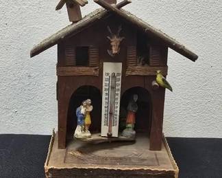Vintage Swiss Weather Prophet Hygrometer – The Keydel Company, Detroit, Michigan
Charming early Swiss-style “Weather House” hygrometer made by The Keydel Company of Detroit, Michigan. Features a rustic chalet design with applied deer head, bird, & hand-painted figurines that rotate in & out of the house to forecast changes in humidity & weather.

• “Weather Prophet” model by The Keydel Co., Detroit, Mich.
• Rotating figures of a witch (for storms) & children (for fair weather)
• Built-in thermometer on front (°F scale)
• Measures approx. 4¾"W x 3⅞"D x 7¼"H
• Original instruction label on back
• Visible age wear consistent with its vintage charm

How It Works:
The movement relies on a fine catgut string inside the structure, which tightens or loosens based on humidity changes. As moisture levels rise before a storm, the witch emerges; as the air dries & clears, the children return—often 8–24 hours in advance of changing conditions.

