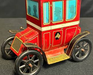 Authentic 1930s Louis Marx Lever Action Limousine Tin Toy
Step back into the 1930s with this Louis Marx “Lever Action” lithographed tin limousine, complete with a bright red body, black roof, & whimsical passenger silhouettes. Operated by a side lever, the toy was designed to propel forward in playful mechanical motion — one of Marx’s earliest automotive toys to capture the prewar fascination with motorcars.
• Marked with the signature Marx horse head emblem on both sides
• Bold red lithograph body with chauffeur & passenger silhouettes
• Lever-action mechanism (untested for function)
• Original black spoked tin wheels with minor rust consistent with age
• Measures approx. 5½" L x 3¾" H
• Displays beautifully with expected surface wear for its 90-year age
