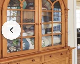 Carved pine cabinet with glass doors. $1800.