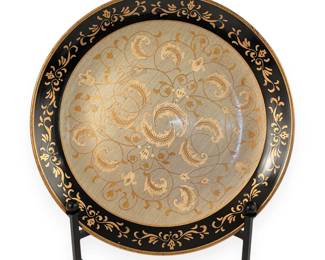 A Decorative Black and Gold Painted Wood or Lacquered Charger Plate with Botanical Motifs