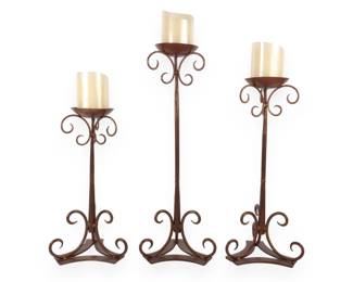 A Set of Three Traditional Scrolled Metal Floor-Standing Pillar Candle Holders