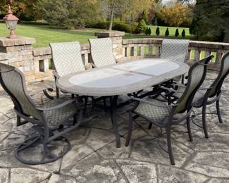 TROPITONE OVAL STONE TABLE WITH SIX CHAIRS 
TWO SWIVEL AND FOUR ROCKERS